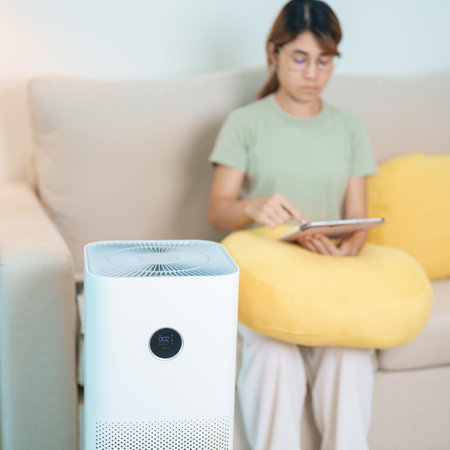 Air Purifier with woman relax and use tablet on sofa. Purification system for filter and cleaning dust PM2.5 HEPA and virus in home. Allergy, Pure air, health, Wellness lifestyle and Air Pollutionの写真素材