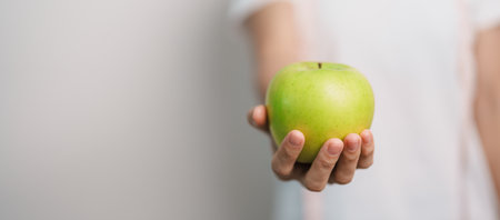 woman hand hold green Apple, happy female fitness choose fruit is Healthy food. Dieting control, Weight loss, Obesity, eating lifestyle and nutrition conceptsの写真素材