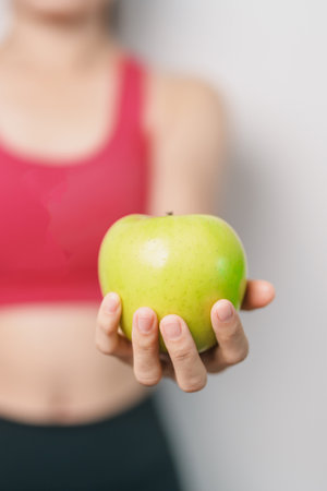 woman hand hold green Apple, happy female fitness choose fruit is Healthy food. Dieting control,...
