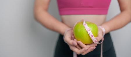 woman hand hold green Apple, happy female fitness choose fruit is Healthy food. Dieting control, Weight loss, Obesity, eating lifestyle and nutrition conceptsの写真素材