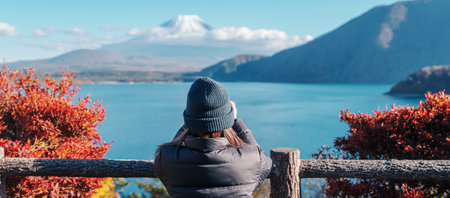 Woman tourist with Fuji Mountain at Lake Motosu in Autumn season, happy Traveler travel Mount Fuji, Yamanashi, Japan. Landmark for tourists attraction. Japan Travel, Destination and Vacationの写真素材