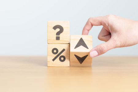 wood block of Question mark with percentage change to UP and Down arrow. Interest rate, GDP, stocks...