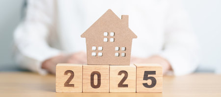 Happy New Year 2025 with house model. real estate, Home loan and mortgage, tax, investment,...