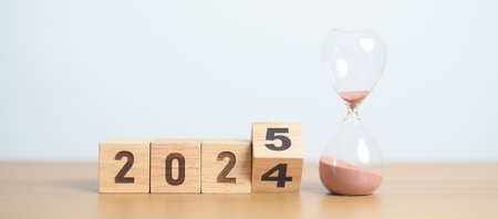 2024 end year to Happy New Year 2025 with hourglass on table. Resolution, time, plan, goal, motivation, reboot, countdown and New Year holiday conceptsの写真素材