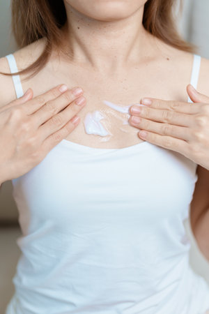 Skin care lotion and Skin body cream Moisturizing, Sunscreen and Healthy Daily Routine concepts. Beauty Woman applying moisturizing skincare cream on hand and body at homeの写真素材