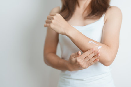 Skin care lotion and Skin body cream Moisturizing, Sunscreen and Healthy Daily Routine concepts. Beauty Woman applying moisturizing skincare cream on arm and body at homeの写真素材