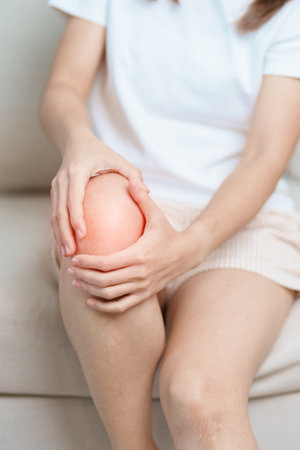 woman having knee ache and muscle pain due to Runners Knee or Patellofemoral Pain Syndrome, osteoarthritis, arthritis, rheumatism and Patellar Tendinitis. medical conceptの写真素材