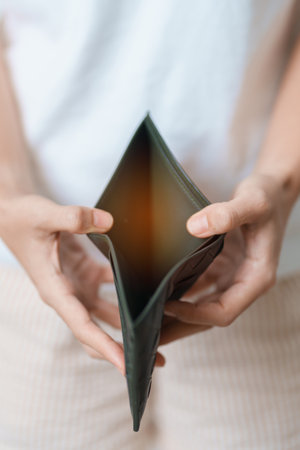 Woman hand holding and open empty wallet with not have banknote money. Crisis, loan, bankrupt and...