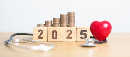 Happy New Year 2025 with doctor Stethoscope, coins stack and red heart on table. health care, Money...