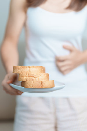 Gluten intolerance, Gluten free and celiac disease or wheat allergy concept. woman hold Bread and...