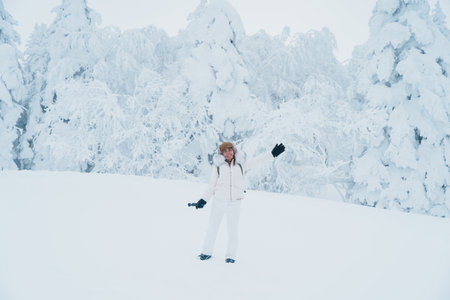 Woman tourist sightseeing Snow monster in Winter day at Mount Zao, Yamagata prefecture, Japan. Happy Traveler walking on powder snow covered in frosty weather. Travel, Adventure and Vacationの写真素材