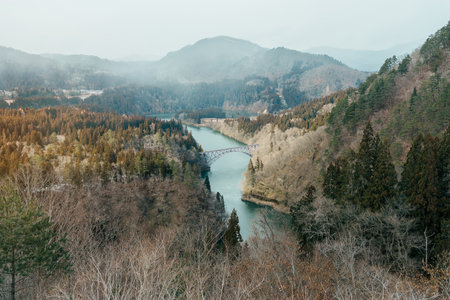 Panoramic View of Japan local train with Tadami river and bridge. Tadami Railway Line in The Valley at Mishima Machi, Aizu, Fukushima Prefecture, Japan. Landmark and iconic spot for tourist attractionの写真素材