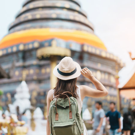 Young asian woman traveler in white dress with hat and bag traveling in Wat Phra That Lampang Luang, Tourist visit at Lampang, Thailand.. Asia Travel, Vacation and summer holiday conceptの写真素材