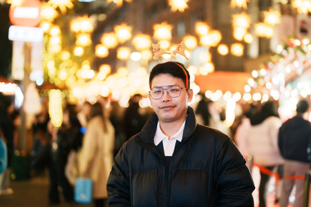 happy tourist man stands on a German christmas market.  Merry Christmas, holiday and happy New Year conceptの写真素材