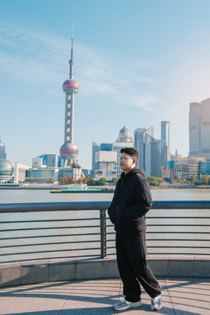 man traveler visiting in Shanghai, China. male Tourist sightseeing Shanghai view of Lujiazui in The Bund of Shanghai. landmark and popular for tourism attractions. Vacation conceptの写真素材