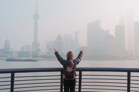 young Asian woman wearing respiratory mask protect and filter pm or particulate matter against bad...