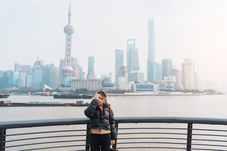woman traveler visiting in Shanghai, China. Happy Female Tourist sightseeing Shanghai view of...