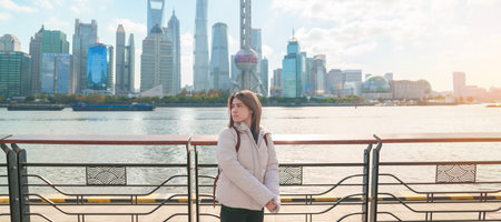 woman traveler visiting in Shanghai, China. Happy Female Tourist sightseeing Shanghai view of...