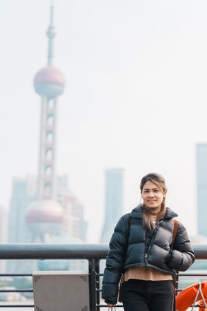 woman traveler visiting in Shanghai, China. Happy Female Tourist sightseeing Shanghai view of Lujiazui in The Bund of Shanghai. landmark and popular for tourism attractions. Vacation conceptの写真素材