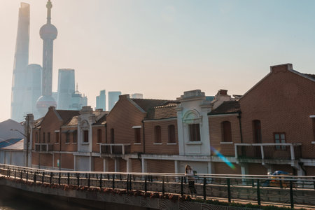 woman traveler visiting in Shanghai, China. Female Tourist with backpack sightseeing Shanghai view of Lujiazui in Hongkou Gang canal of Shanghai. landmark and popular for tourism attractionの写真素材