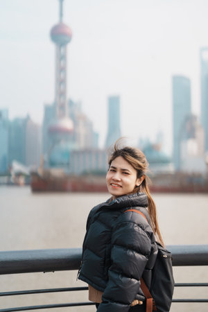 woman traveler visiting in Shanghai, China. Happy Female Tourist sightseeing Shanghai view of...