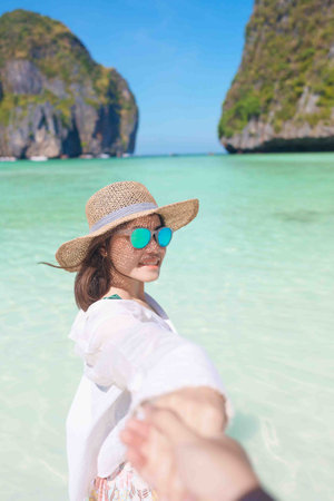 Couple tourist traveling and sightseeing in Krabi, Thailand. happy traveller enjoy at Maya Bay beach on Phi Phi island. Honeymoon trip, destination, Southeast Asia Travel, vacation and holiday conceptの写真素材