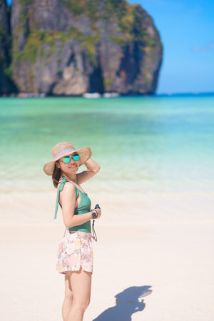 Woman tourist traveling and sightseeing in Krabi, Thailand, happy traveller enjoy at Maya Bay beach on Phi Phi island, Popular paradise island, destination, Southeast Asia Travel, vacation and holidayの写真素材