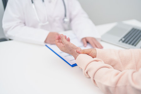 Elderly Patient Woman wrist pain and Consulting doctor. muscle ache from Carpal Tunnel Syndrome, De Quervain s tenosynovitis, rheumatoid, arthritis, gout, Parkinson disease and ergonomic healthcareの写真素材