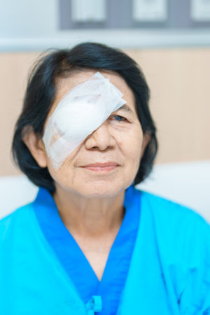 Elderly Woman with eye protective shield after eye surgery. Eye disease, Cataract,  Glaucoma, Age...