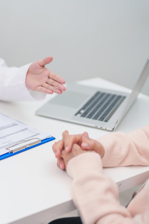 Doctor explaining diagnosis and treatment plan to elderly patient during hospital appointment....