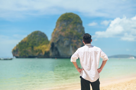 man tourist travel and sightseeing in Krabi, Thailand. happy traveller enjoy on beach at Phra nang Cave Beach near Railay Beach. summer trip, destination, Southeast Asia Travel and vacation conceptの写真素材