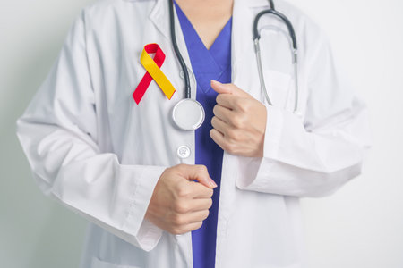 World hepatitis day awareness month, 28 July. Doctor holding Red and Yellow ribbon. Liver cancer, Jaundice, Cirrhosis, Failure, Enlarged, Hepatic Encephalopathy and Health conceptの写真素材