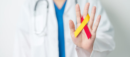 World hepatitis day awareness month, 28 July. Doctor holding Red and Yellow ribbon. Liver cancer, Jaundice, Cirrhosis, Failure, Enlarged, Hepatic Encephalopathy and Health conceptの写真素材