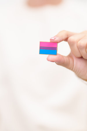 Bisexuality Celebrate Day and LGBT pride month, LGBTQ or LGBTQIA concept. Hand holding purple, pink and blue flag shape for Lesbian, Gay, Bisexual, Transgender, Queer, Pansexual, Marriage Equality Lawの写真素材