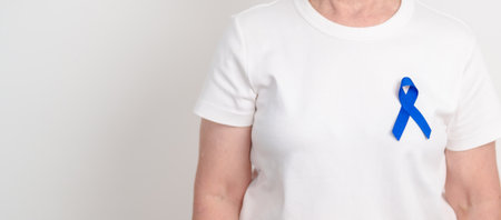 Elderly with dark Blue or Navy blue Ribbon for concept of March Colorectal and Colon Cancer...