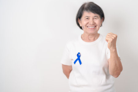 Elderly with dark Blue or Navy blue Ribbon for concept of March Colorectal and Colon Cancer Awareness month, May Arthritis awareness, July Juvenile arthritis and Childhood. Health and world cancer dayの写真素材