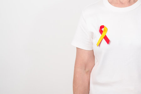World hepatitis day awareness month, 28 July. elderly woman with Red and Yellow ribbon. Liver cancer, Jaundice, Cirrhosis, Failure, Enlarged, Hepatic Encephalopathy and Health conceptの写真素材