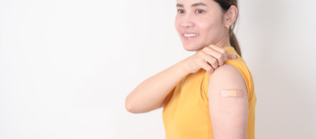 Adult Woman with bandage after received vaccine. Vaccination and Immunization for Influenza, HPV, Zoster, IPD, DTP or Diphtheria, Tetanus and Pertussis, MMR, Hepatitis B, Covid and Varicella vaccineの写真素材