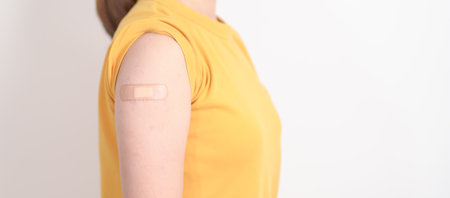 Adult Woman with bandage after received vaccine. Vaccination and Immunization for Influenza, HPV, Zoster, IPD, DTP or Diphtheria, Tetanus and Pertussis, MMR, Hepatitis B, Covid and Varicella vaccineの写真素材