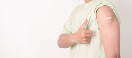 Adult Man with bandage after received vaccine. Vaccination and Immunization for Influenza, HPV, Zoster, IPD, DTP or Diphtheria, Tetanus and Pertussis, MMR, Hepatitis B, Covid and Varicella vaccineの写真素材