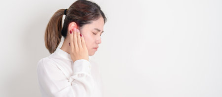 Business Woman having Ear pain for concept of Ear disease, Atresia, Otitis Media, Infection, Pertorated Eardrum, Meniere syndrome, Otolaryngologist, Hearing Loss, Hyperacusis, Tinnitus and Earwaxの写真素材