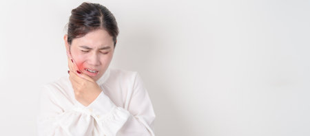 Business woman having Toothache and pain. Oral Teeth decay and Gum disease, Scrape off tartar. March Oral health, Dentist Day, False Teeth. Toothache and Dental Health Month and Orthodontic Health Dayの写真素材