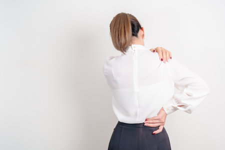 Business woman having back body ache for concepts of Back Muscle Strain, Piriformis Syndrome, Low Back Pain, Lumbar Disc Degeneration, Herniated, Osteoporosis, Spinal Compression and Office syndromeの写真素材