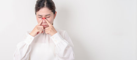 Business Woman having Nose pain for concepts of Nose disease, Common Cold, Influenza, Flu, Covid 19, Respiratory Infection, Sinusitis, Allergic Rhinitis, Asthma, Allergy, Dry nose Anosmia and Healthの写真素材