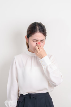 Business Woman having Nose pain for concepts of Nose disease, Common Cold, Influenza, Flu, Covid 19, Respiratory Infection, Sinusitis, Allergic Rhinitis, Asthma, Allergy, Dry nose Anosmia and Healthの写真素材
