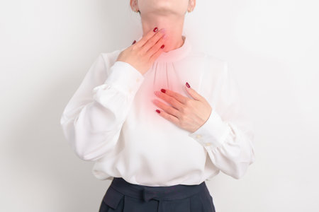 Gastroesophageal Reflux Disease or GERD, Acid reflux disease, Gastro Oesophageal or GORD and Dyspepsia concept. Business woman having Stomach ache and Esophageal pain due to Digestion system problemの写真素材