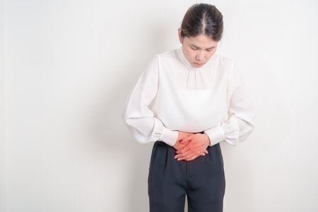 Business woman having Colon pain for Colonic disease, Inflammatory Bowel, IBD, Colorectal cancer, Ulcerative colitis, Diverticulitis, Irritable bowel syndrome, Digestive system and Health conceptの写真素材