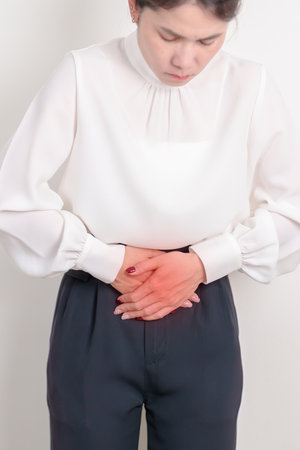 Business woman having Colon pain for Colonic disease, Inflammatory Bowel, IBD, Colorectal cancer, Ulcerative colitis, Diverticulitis, Irritable bowel syndrome, Digestive system and Health conceptの写真素材