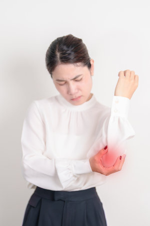 Business Woman having elbow ache for concepts of Tennis Elbow, muscle pain and Sprain, lateral epicondylitis, Bursitis, injury, Office syndrome, Health care and medicalの写真素材