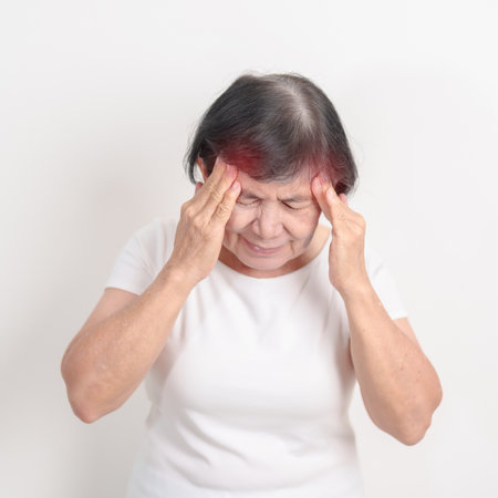 Elderly Woman having headache and Dizzy for concepts of Chronic Stress, Headache and Migraine, World Brain Tumor day, Brain Cancer, Brain Stroke, Dementia, alzheimer, Hypotension and mental healthの写真素材